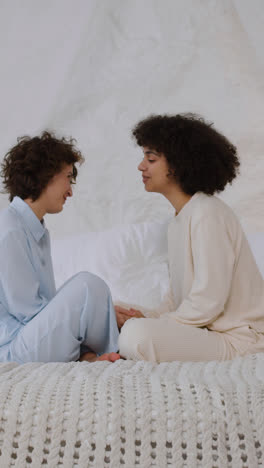 Happy-couple-talking-on-bed