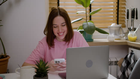 Girl-using-smartphone-and-laptop