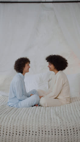 Happy-couple-sitting-on-bed