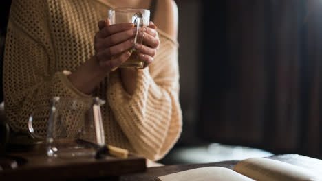 Person-holding-cup-of-tea