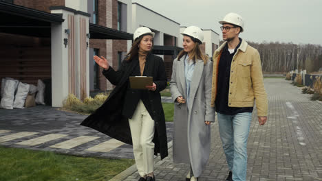 People-with-hardhats-talking-and-walking-outdoors