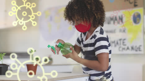 Digital-composition-of-multiple-covid-19-cells-floating-against-boy-wearing-face-mask-spraying-water