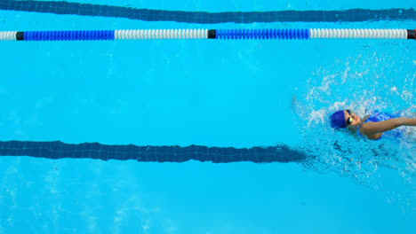 High-angle-view-of-young-female-swimmer-swimming-inside-pool-4k