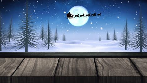 Animation-of-black-silhouette-on-santa-claus-in-sleigh-being-pulled-by-reindeer-with-winter-scenery-