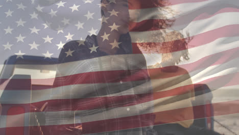 Mixed-race-young-women-with-US-flag-waving-foreground