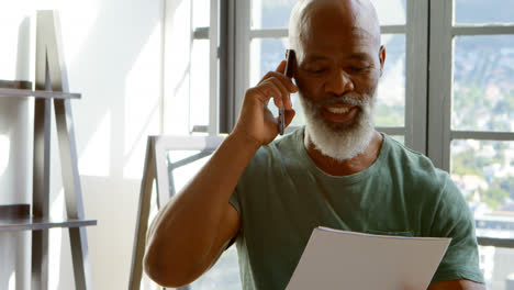 Senior-man-talking-on-mobile-phone-at-home-4k