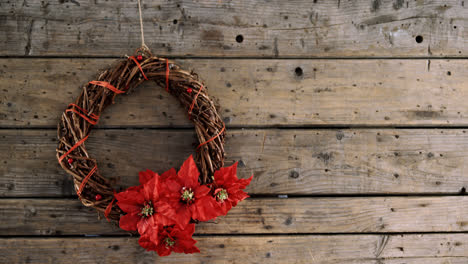 Grapevine-wreath-with-flowers-on-wooden-table-4k