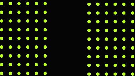 Green-and-yellow-triangles-and-white-flashes-moving-on-a-black-background-with-yellow-dots