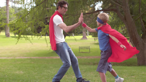 Wow-text-on-speech-bubble-against-son-giving-high-five-to-his-dad