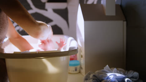 Mother-giving-her-baby-boy-a-bath-in-bathroom-4k