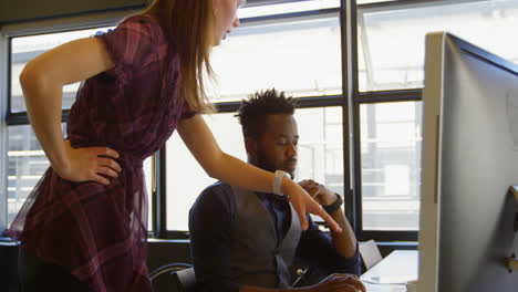 Side-view-of-young-cool-mixed-race-business-team-planning-and-working-at-desk-in-a-modern-office-4k