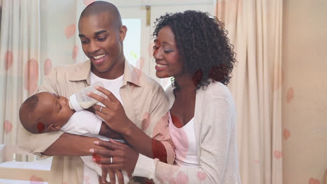 Digital-composite-of-happy-parents-feeding-milk-to-son