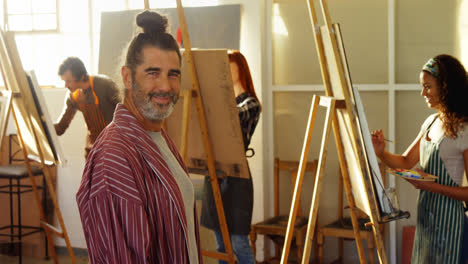 Portrait-of-artist-standing-in-drawing-class-4k