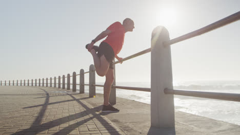 Senior-man-stretching-his-legs-on-the-promenade