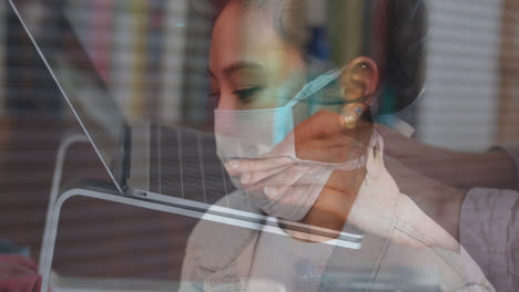 Woman-in-face-mask-coughing-against-mid-section-of-student-using-laptop