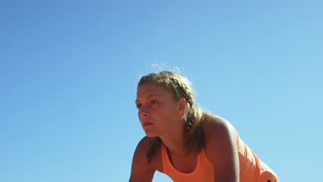 Front-view-of-Caucasian-female-athlete-taking-starting-position-on-a-running-track-at-sports-venue-4