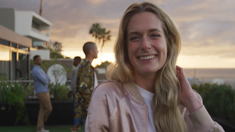 Young-Caucasian-woman-smiling-at-camera-on-a-rooftop