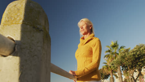 Side-view-of-senior-woman-in-front-of-beach