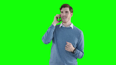 Caucasian-man-talking-by-phone-on-green-background