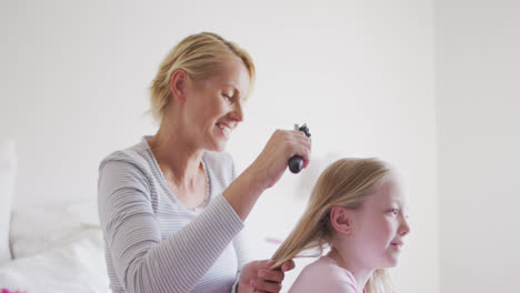 Seitenansicht-Einer-Kaukasischen-Frau,-Die-Ihrer-Tochter-Die-Haare-Bürstet