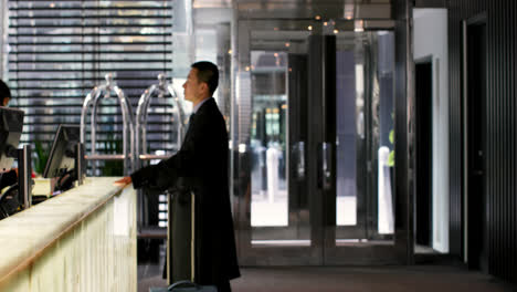 Side-view-of-mixed-race-business-people-standing-at-reception-in-hotel-4k