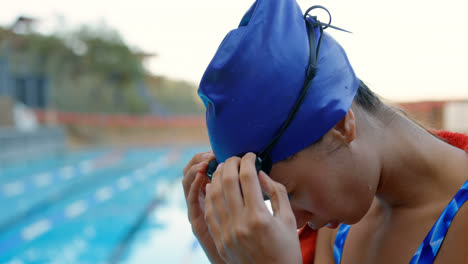 Female-swimmer-removing-swim-goggle-4k