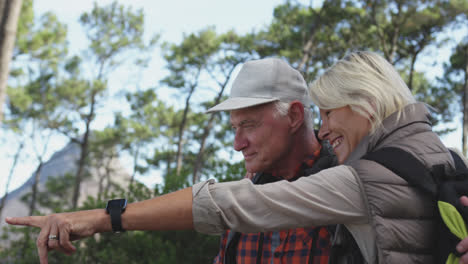 Side-view-of-active-senior-couple-in-forest