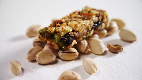 Pistachio-and-granola-bar-on-white-background-4k