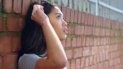 Young-woman-standing-against-wall-4k