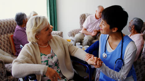 Front-view-of-Asian-female-doctor-interacting-with-senior-woman-at-nursing-home-4k