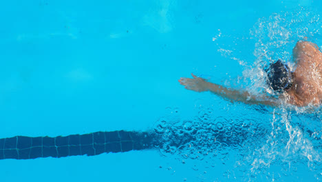 High-angle-view-of-male-swimmer-swimming-inside-pool-4k