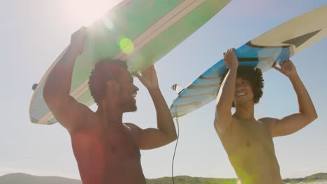 Young-friends-carrying-surfboard-on-head-4k