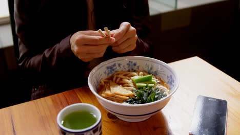 Woman-having-noodles-in-restaurant-4k