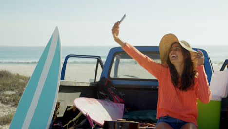 Woman-taking-selfie-with-mobile-phone-near-car-4k