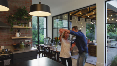 Happy-couple-dancing-in-the-kitchen