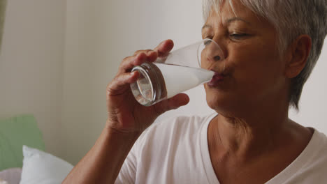 Senior-woman-in-social-taking-her-medication