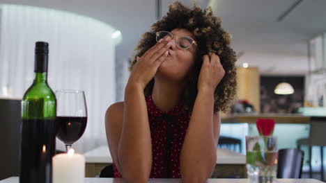 Mujer-De-Raza-Mixta-Teniendo-Una-Cena-Romántica-Lanzando-Besos-En-Video-Chat-En-Casa