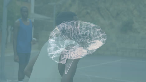 Human-brain-model-spinning-against-african-american-man-playing-basketball-on-basketball-court