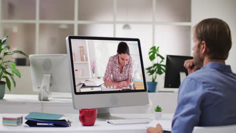 Caucasian-male-teacher-using-computer-on-video-call-with-female-student