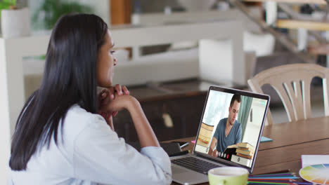 Caucasian-female-teacher-using-laptop-on-video-call-with-male-student