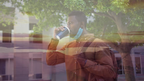 Sunset-landscape-against-african-american-man-with-lowered-face-mask-drinking-coffee-outdoors