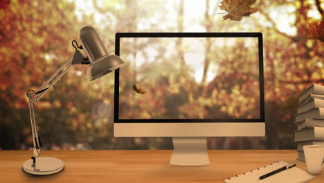 Animation-of-leaves-falling-over-laptop-and-computer-and-desk