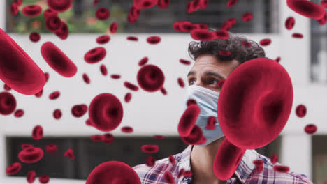 Animación-De-Glóbulos-Rojos-Flotantes-Sobre-Un-Hombre-Que-Lleva-Mascarilla-En-Una-Calle-De-La-Ciudad