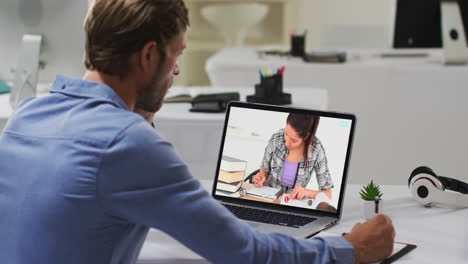 Caucasian-male-teacher-using-laptop-on-video-call-with-female-student