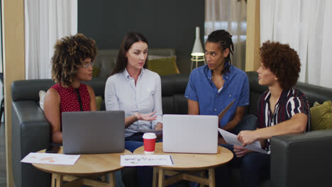 Diverse-business-colleagues-in-discussion-at-a-casual-meeting-in-the-office