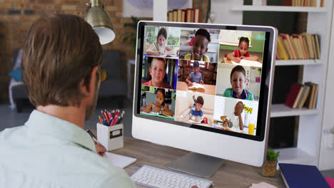 Caucasian-male-teacher-using-computer-on-video-call-with-school-children