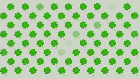 Digital-animation-of-multiple-clover-leaves-flickering-against-grey-background