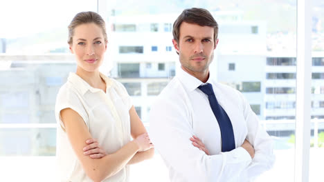 Smiling-business-team-looking-at-camera