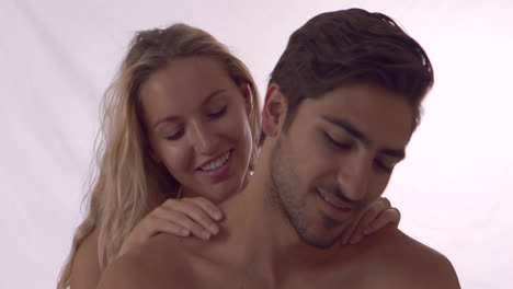 Blonde-girl-giving-her-boyfriend-a-shoulder-rub