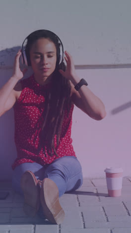 Animation-of-scope-scanning-over-biracial-woman-sitting-and-wearing-headphones